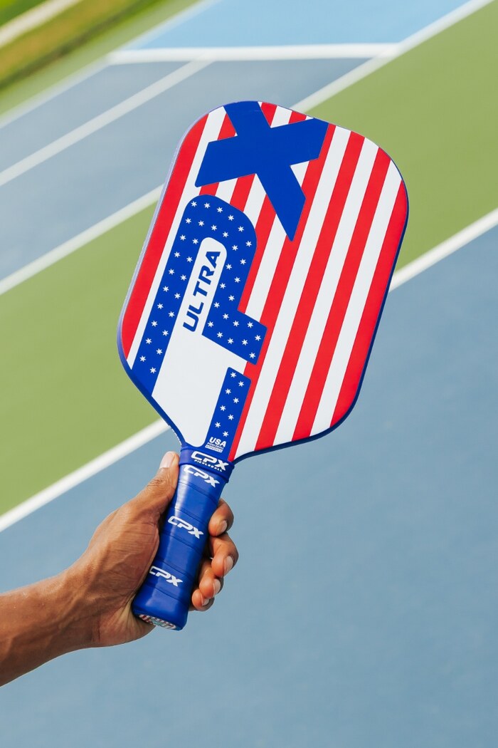 Player holding CPX Ultra paddle on the court